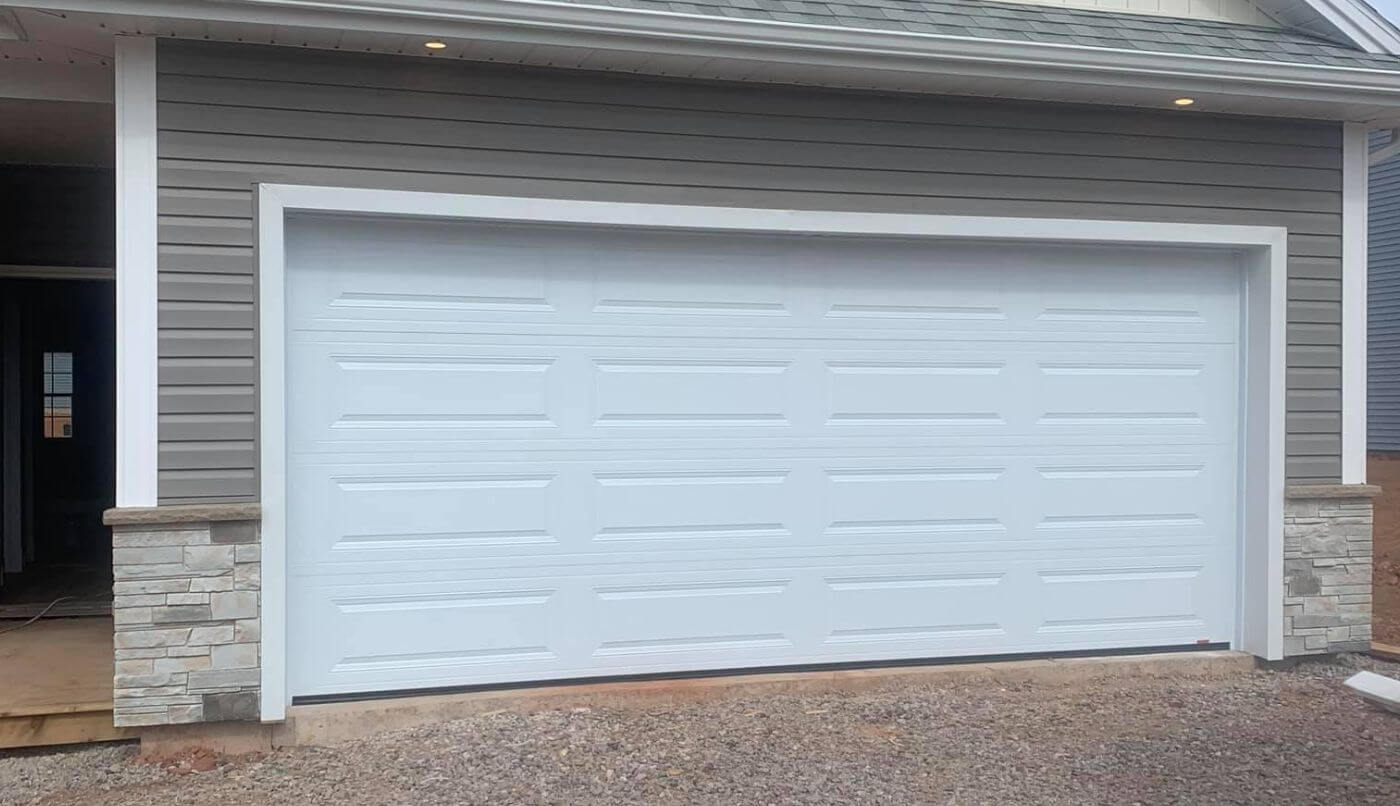 The image features a white garage door, highlighting its sleek appearance and integration into the home’s exterior.