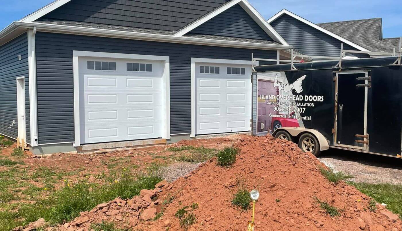 Two stylish white garage doors and white trim, reflecting a modern and clean aesthetic.